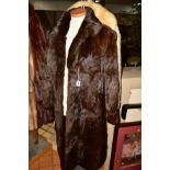 A LADIES PERSIAN LAMB THIGH LENGTH COAT, having cream mink collar, side pocket, half belt to the