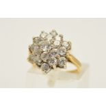 A 9CT GOLD CLUSTER RING, designed as a tiered cluster of circular colourless pastes, with 9ct