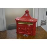 A MODERN RED GROUND WALL MOUNTED LETTER BOX (two keys)