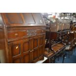 AN OAK FALL FRONT BUREAU together with a mahogany sofa table with two drawers, mahogany suit stand