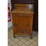 AN EARLY 20TH CENTURY GEOMETRIC STYLE SINGLE DOOR CUPBOARD with a gallery top, width 61cm x depth