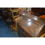 AN OAK GEOMETRIC FALL FRONT BUREAU, together with an oak drop leaf dining table, two chairs, a