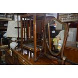 AN EDWARDIAN MAHOGANY SHIELD TOILET MIRROR together with a mahogany folding cake stand, oak umbrella