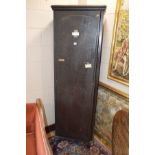 A TALL VICTORIAN STAINED PINE PANELLED SINGLE DOOR SCHOOL CUPBOARD, the interior with various