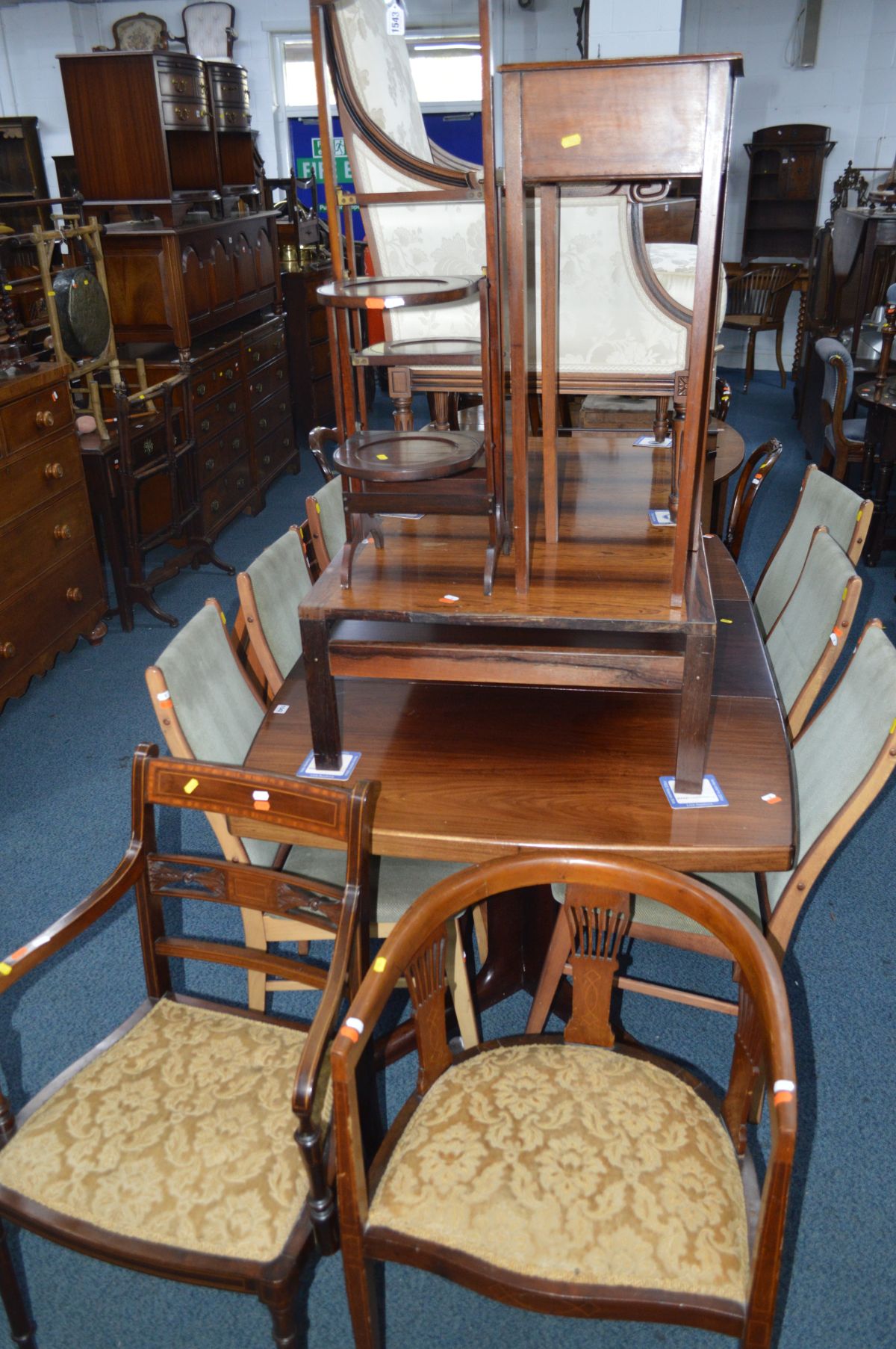 AN EDWARDIAN MAHOGANY DOUBLE SIDED FOLDING CAKE STAND together with an Edwardian plant stand,