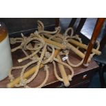 A TEN RUNG ROPE LADDER with beechwood round rungs, a 180cm lead on and made of 16mm rope