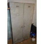 A STEEL DOUBLE DOOR LOCKER with five shelves and a drawer, height 180cm x width 92cm x depth 57cm