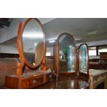 A REPRODUCTION MAHOGANY OVAL DRESSING MIRROR, together with a triple dressing mirror, nest of