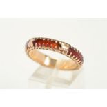 A CARNELIAN RING, an eternity style ring claw set with four faceted pieces of carnelian, ring size