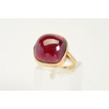 A GARNET RING, designed as a cushion-shape garnet within a collet setting to the plain band, stamped