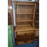 A PINE BOOKCASE with two drawers, width 95cm x depth 50cm x height 196cm and a folding deck chair (