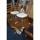 AN ERCOL GOLDEN DAWN EXTENDING PEDESTAL DINING TABLE, one additional leaf, extended width 148cm x