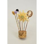 SEVEN STICKPINS, to include a faceted amethyst stickpin, an oval cameo stickpin, a bone flower