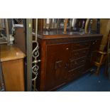 AN ART DECO OAK MIRROR BACK SIDEBOARD with four central drawers, width 138cm x depth 48cm x height