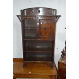 AN EARLY TO MID 20TH CENTURY OAK OPEN BOOKCASE with a single door, width 67cm x depth 23cm x