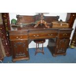 AN EARLY 20TH CENTURY MAHOGANY SIDEBOARD, carved with foliate and scrolled decoration, with a raised