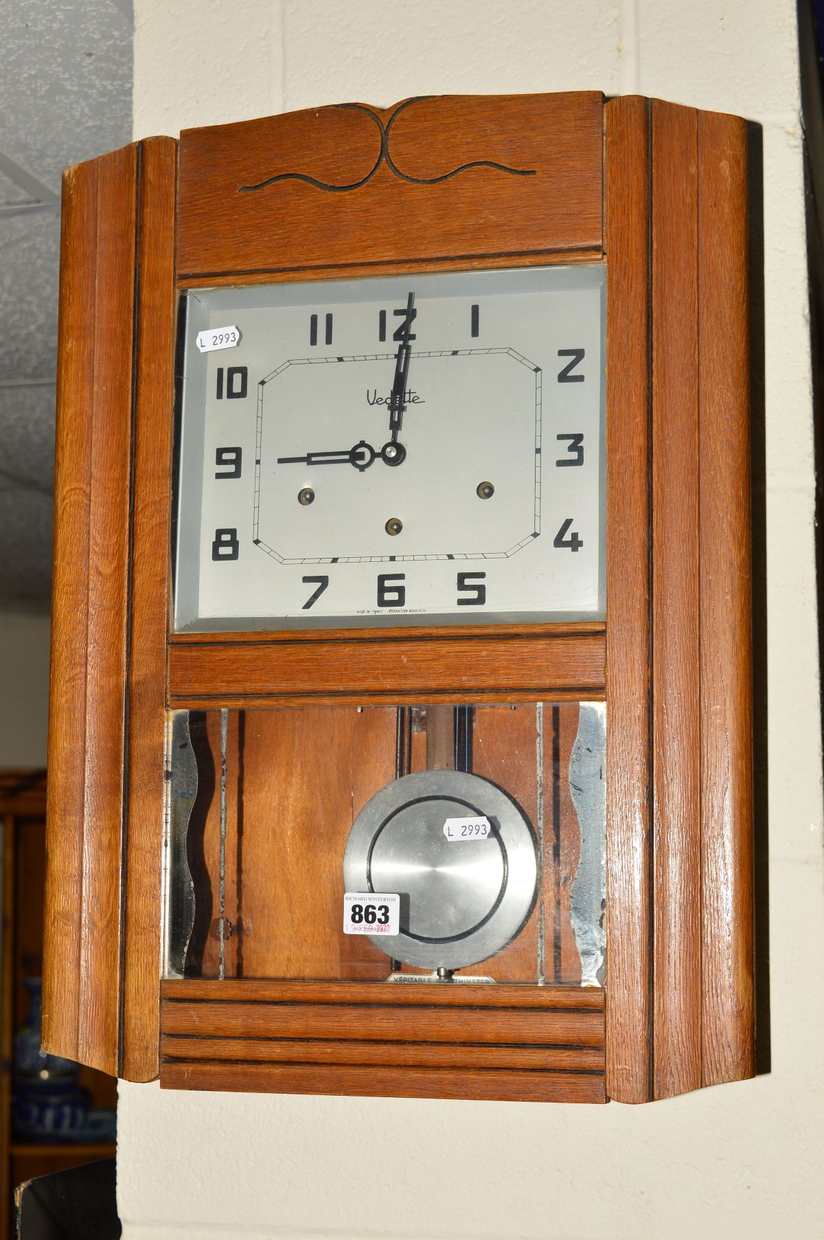 AN OAK VEDETTE DROP DIAL WALL CLOCK, having Arabic numerals, pendulum and key