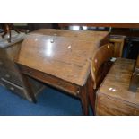 A GEORGIAN OAK FALL FRONT BUREAU with one drawer and standing on block legs, width 91cm x depth 53cm