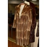TWO FUR COATS, to include a musquash fur coat with wide lapel collar, four hook fastenings and inner