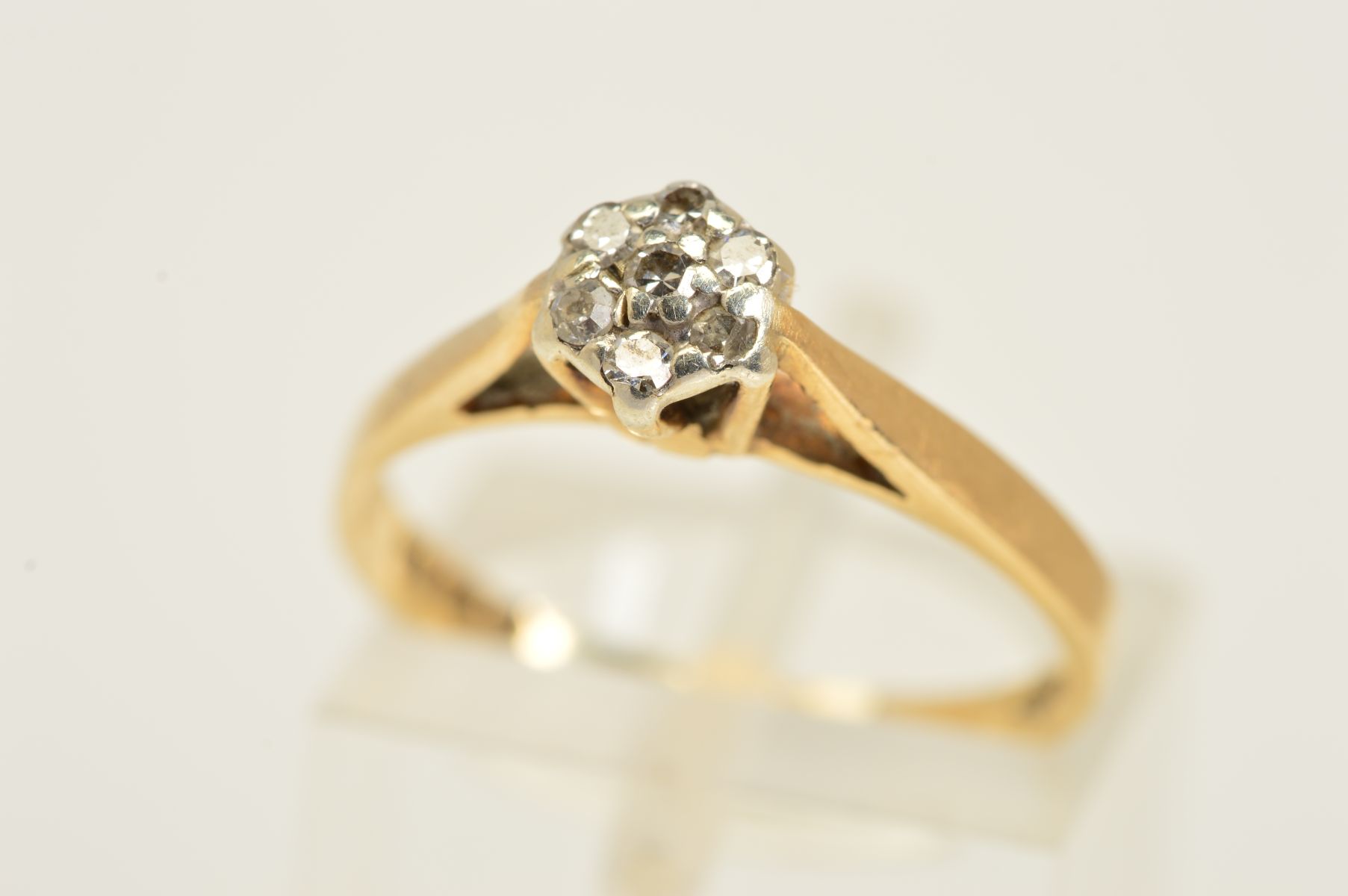 A 9CT GOLD DIAMOND RING, designed as a cluster of seven single cut diamonds, with 9ct hallmark for