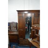 AN OAK SINGLE MIRROR DOOR WARDROBE above a single long drawer, together with a chest of three long