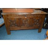 A GEORGIAN OAK TRIPLE PANEL COFFER, with intertwined swag decoration, width 117cm x depth 56cm x