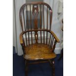 A LATE 19TH/EARLY 20TH CENTURY OAK AND ELM SPINDLED WINDSOR ARMCHAIR, on turned legs united by a