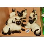 SEVEN BESWICK/ROYAL DOULTON SIAMESE CATS, No1558, No1559, DA125, and four No1887/D129 (7)