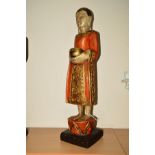 A MODERN CARVED HARDWOOD AND PAINTED DEITY, incorporating black wooden plinth, total height