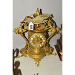 A LATE 19TH CENTURY GILT METAL MANTEL CLOCK, cast with Etruscan style decoration, gilt dial with