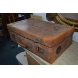 A VINTAGE TAN LEATHER SUITCASE with various travel labels, width 71cm x depth 41cm x height 22cm