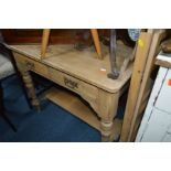 AN EDWARDIAN STRIPPED PINE WASHSTAND with a florally tiled back, turned legs and undershelf, width