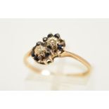 A 9CT GOLD SAPPHIRE AND DIAMOND RING, designed as two diagonal flowers each set with a single cut