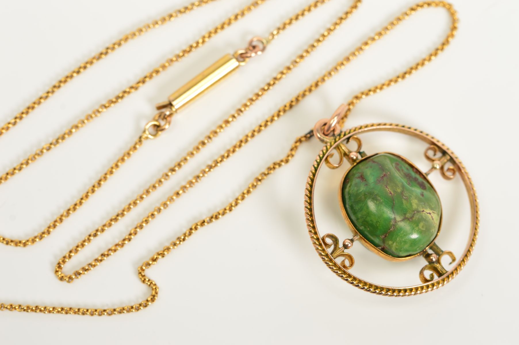 A NECKLACE, designed with a central semi-precious tumble stone within a circular open work