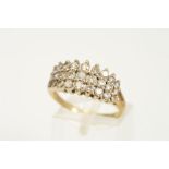 A 9CT GOLD DIAMOND DRESS RING, designed as three graduated rows of claw set brilliant cut