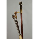 TWO DECORATIVE HANDLED WALKING STICKS AND AN UMBRELLA, one walking stick with an horn handle