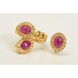 A DIAMOND AND RUBY RING AND EARRINGS SET, the ring designed with a central oval cut ruby cabochon