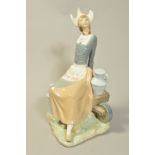 A LARGE LLADRO FIGURE 'Dutch Milkmaid' No4979 milkmaid sat on wheelbarrow, designed by Vincente