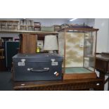 A SMALL OAK DISPLAY CASE with glazed front, sides and to with a painted solid panel to the rear,