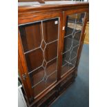 AN OLD CHARM GLAZED DISPLAY CABINET with leaded detailing to the two front doors and both sides, two