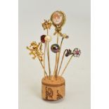 NINE STICKPINS, to include an oval cameo stickpin depicting a lady in an outdoor scene, a red and