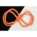 A GRADUATED CORAL BEAD NECKLACE, the spherical beads measuring approximately 3mm to 10mm, to the