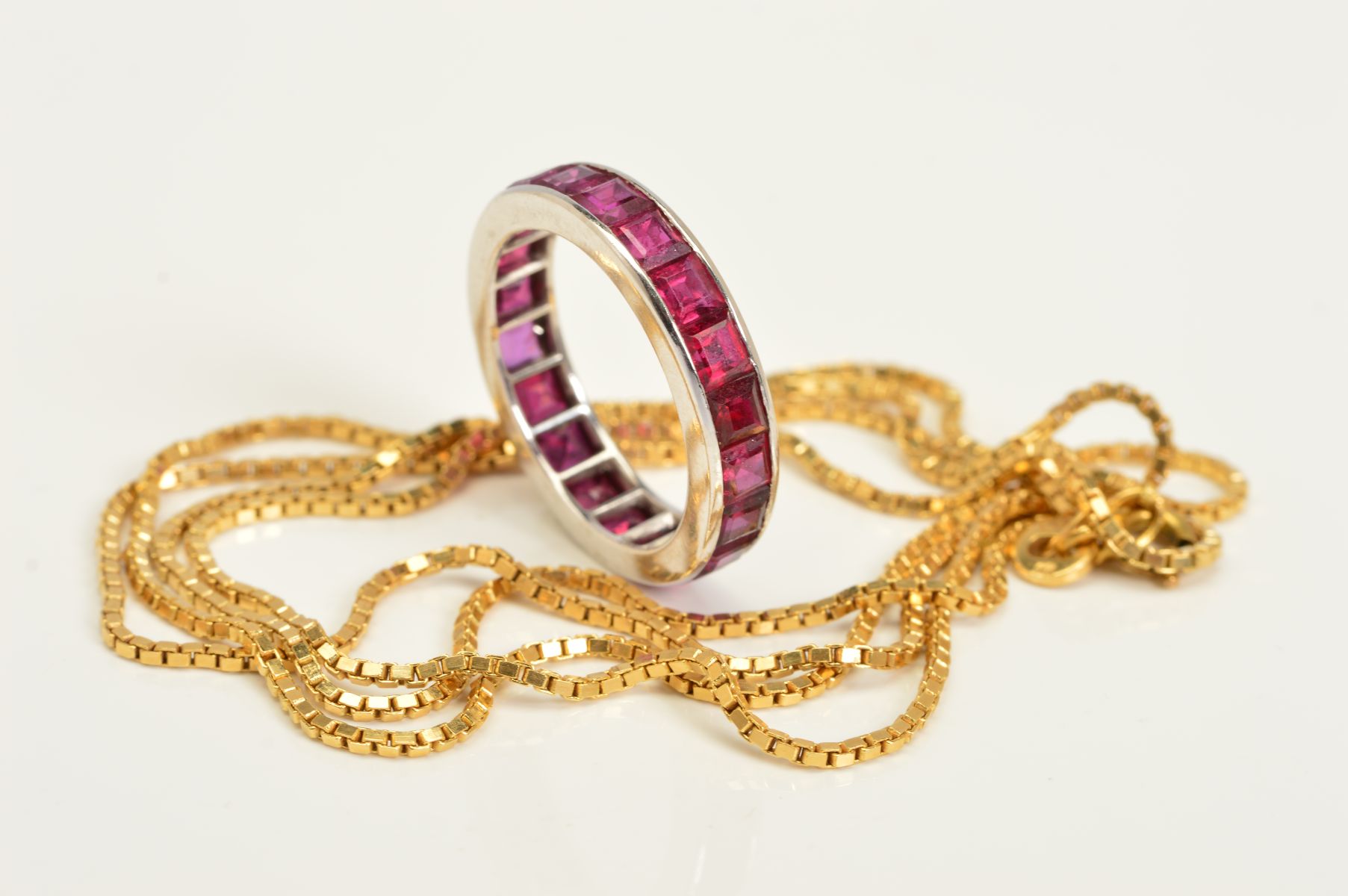 A RING AND A CHAIN, the eternity ring set with square cut rubies in a plain polished band, ring size