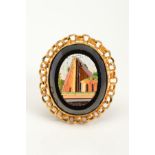 A MICRO MOSAIC PENDANT, of oval outline, the micro mosaic panel depicting buildings, within a