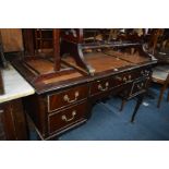 A REPRODUCTION MAHOGANY TAN LEATHER WRITING DESK with five various drawers on cabriole legs, width