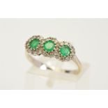 AN 18CT GOLD EMERALD AND DIAMOND TRIPLE CLUSTER RING, designed as three circular emeralds each