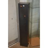 A BLACK PAINTED STEEL GUN CABINET, height 133cm x width 24cm x depth 16cm (two keys)