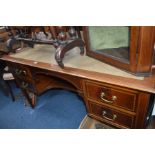 AN EDWARDIAN MAHOGANY AND MARQUETRY BANDED WRITING DESK with four drawers on square tapering legs,