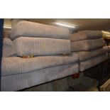 AN OATMEAL FOUR PIECE LOUNGE SUITE comprising of a two seater settee (splits in two), armchair and