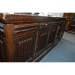 A LONG MODERN OAK SIDEBOARD with four doors and four false drawer fronts (2 keys), 168cm width x